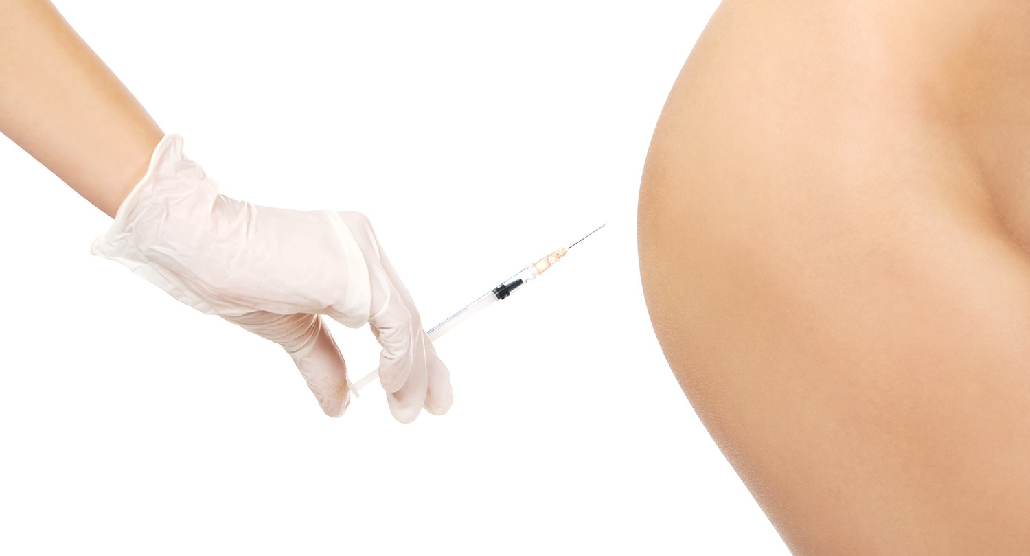 Injection before surgery on a woman's bottom