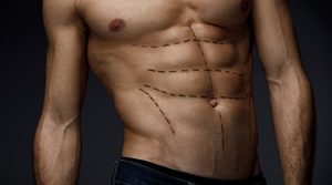 Closeup Of Man With Sexy Fit Body And Black Lines On Skin